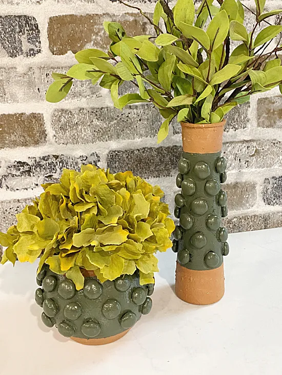 green textured vases with flowers