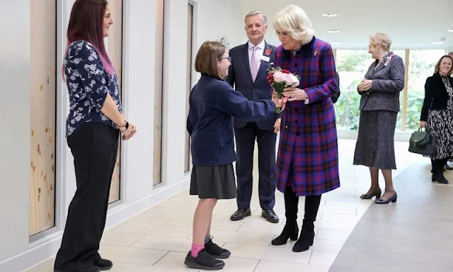 The Duchess wore a bold tartan coat and colour-block scarf, her favourite knee-high boots and Remembrance poppy pin