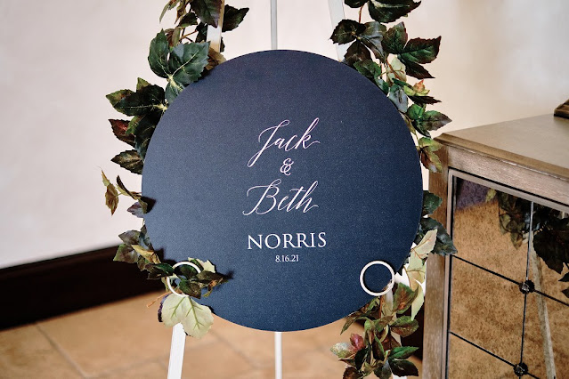 round black wedding welcome sign on easel