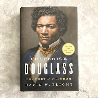 "Frederick Douglass: Prophet of Freedom" book on a grey background.