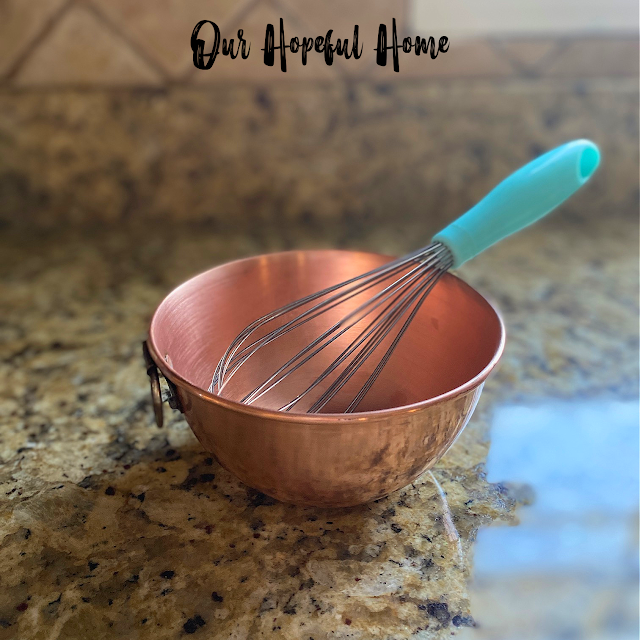 bright shiny copper meringue bowl with whisk