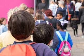 Image of children lining up outside school