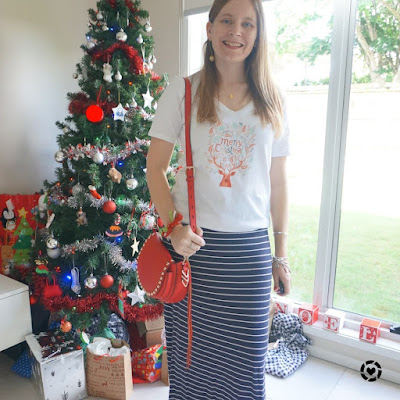 awayfromblue Instagram | festive christmas reindeer tee and navy stripe maxi skirt red saddle bag Christmas eve outfit