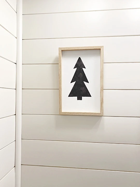 black tree picture and shiplap wall