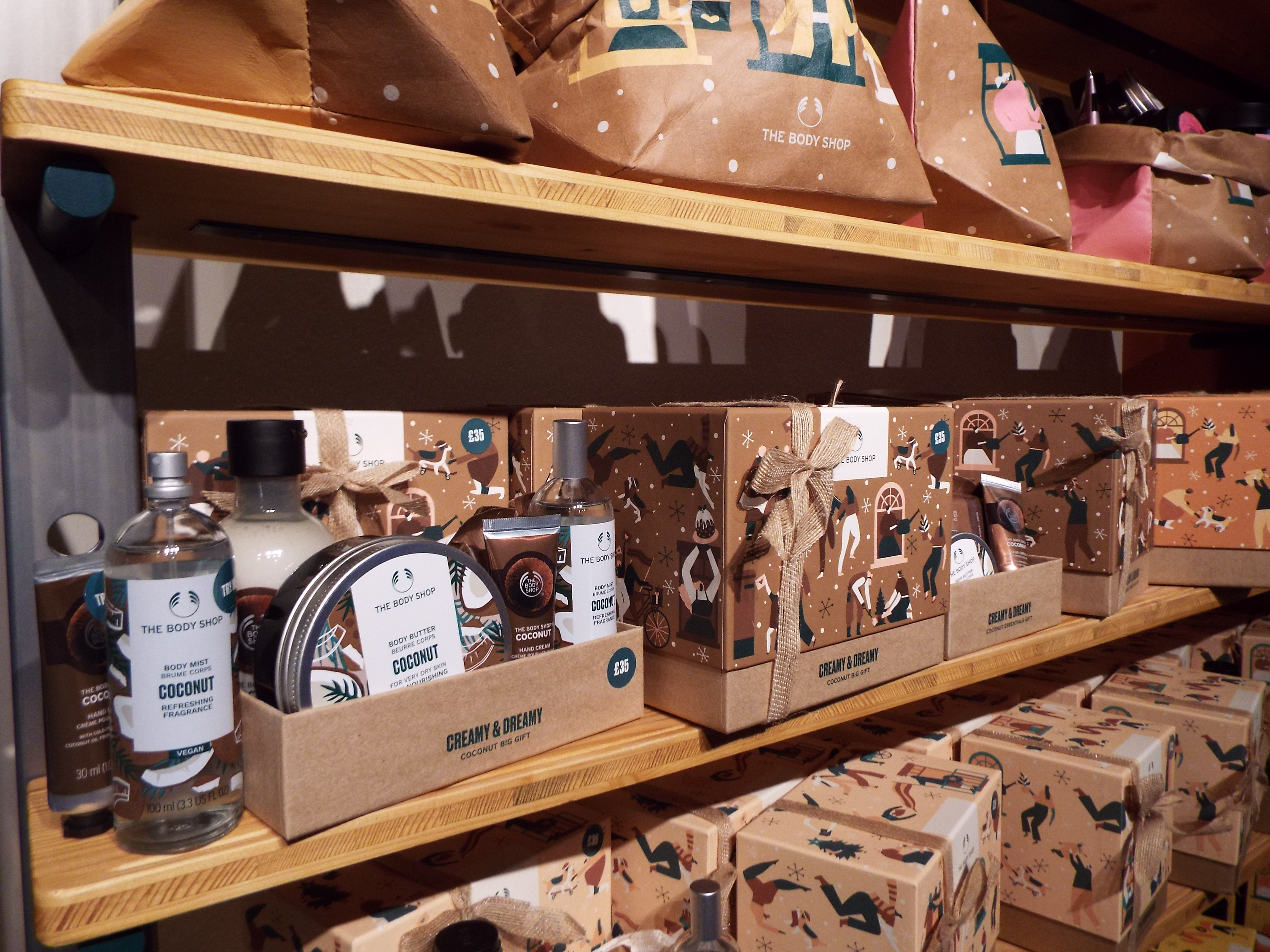 A selection of the coconut collection, dressed in brown paper and cardboard packing on the shelves.