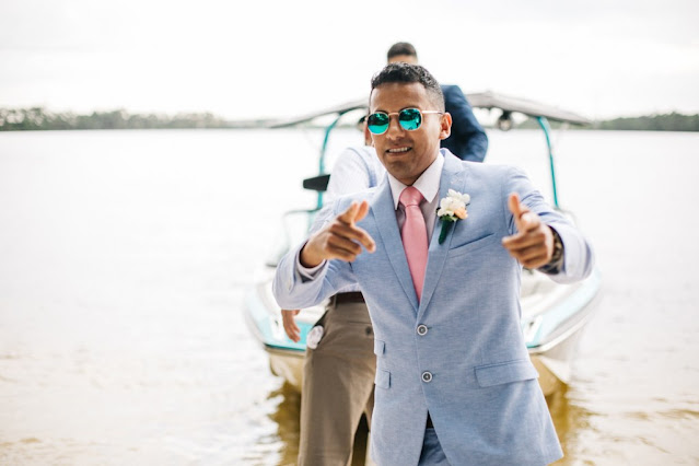 Groom in blue suit on a boat