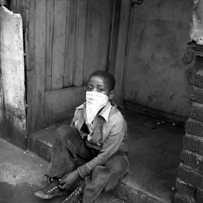 black and white photo of young Boy wearing hankerchief as a mask, New York City, c. 1946 by Sonia Handelman Meyer.