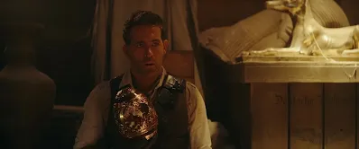 Ryan Reynolds with Golden Egg Screenshot Red Notice Movie