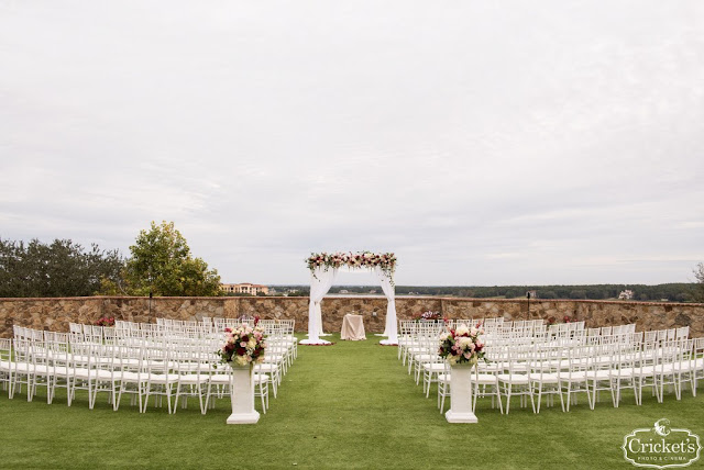 bella collina wedding ceremony setup on grand lawn with white chairs