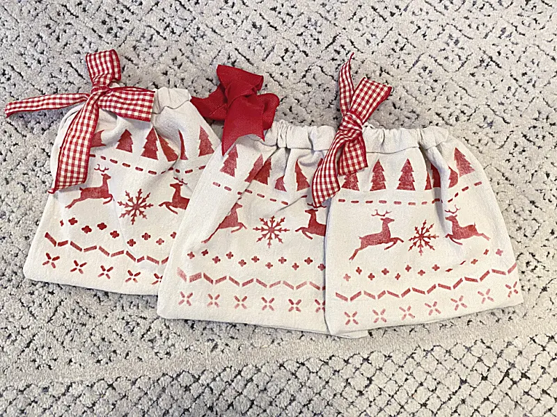 three stenciled gift bags