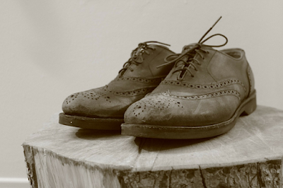 An old Pair of Leather Bogue Shoes Lying on Wood