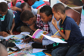 Picture of children gathered around books