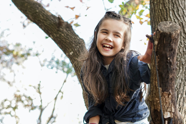 little girl climbing a tree
