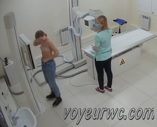 Spy camera catches woman taking off her bra to view thorax on the X-ray apparatus (X-ray Examination 11-21)