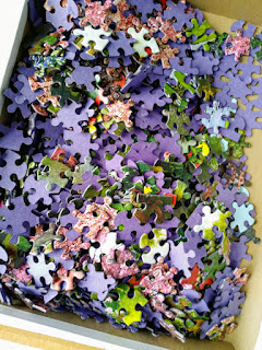 one thousand puzzle pieces in an open box