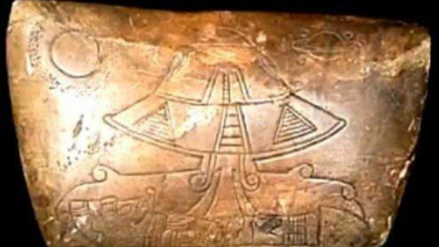 A UFO is carved onto an ancient stone tablet.