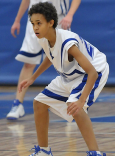 Derrick White in a defensive stance during a game at Legend High School