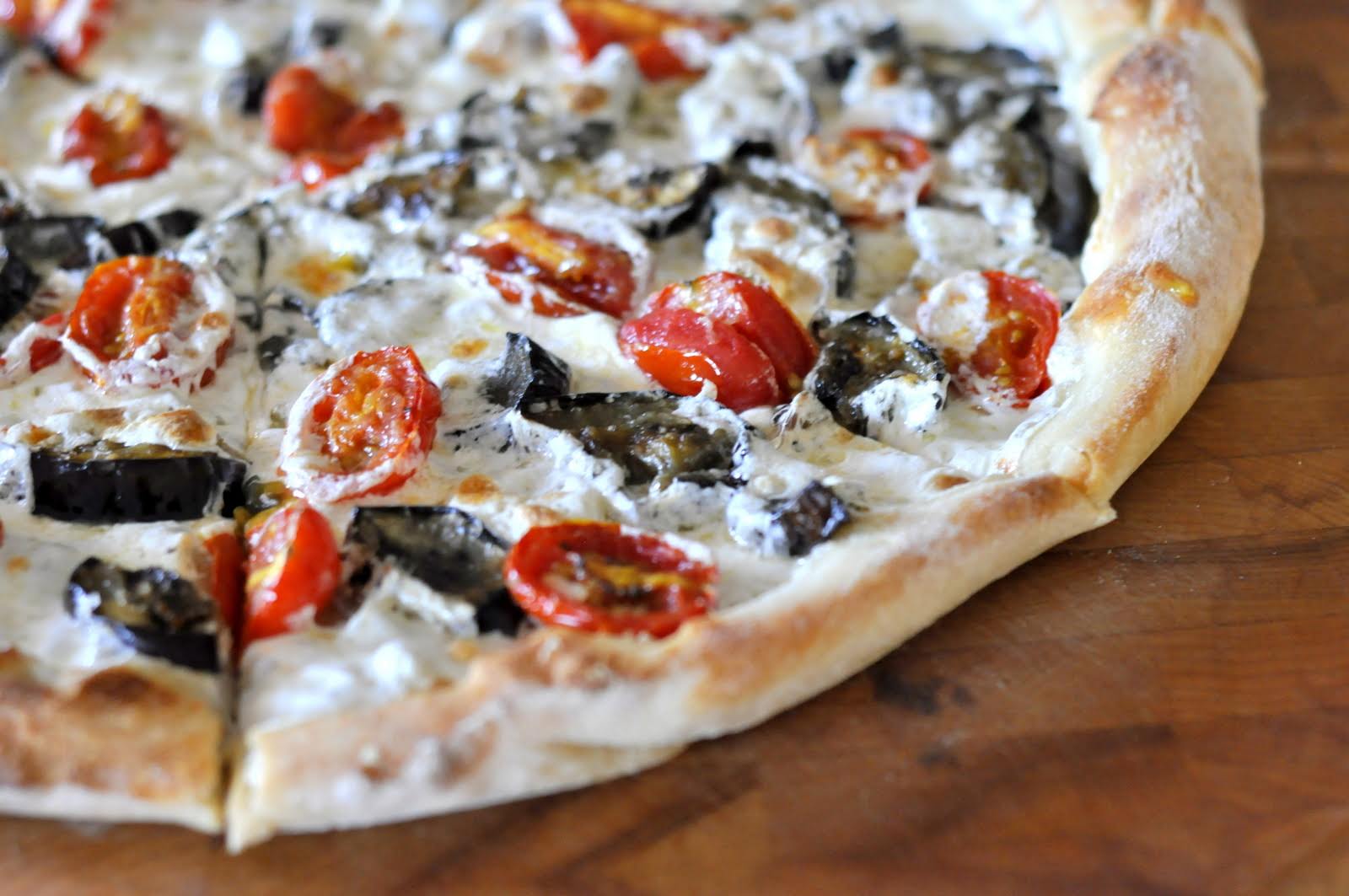 Pizza with Eggplant, Grape Tomatoes, and Fresh Mozzarella on wooden cutting board | Taste As You Go