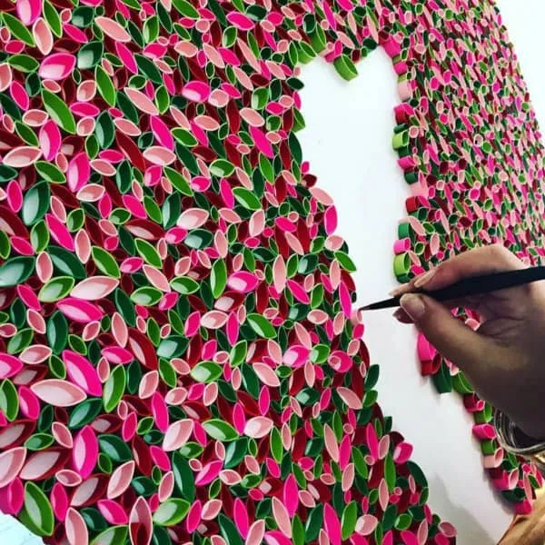 large scale quilled paper art composed of open marquise coils in greens and pinks