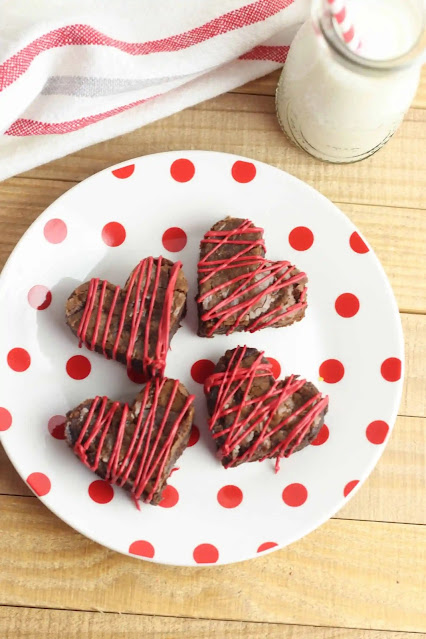 brownies on a white and red polka dot plate.