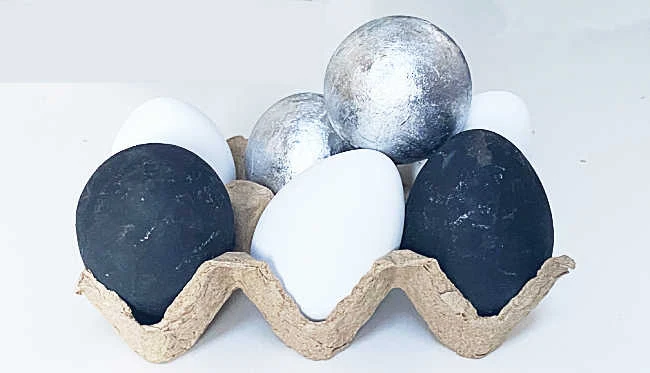 carton of black, white and silver eggs