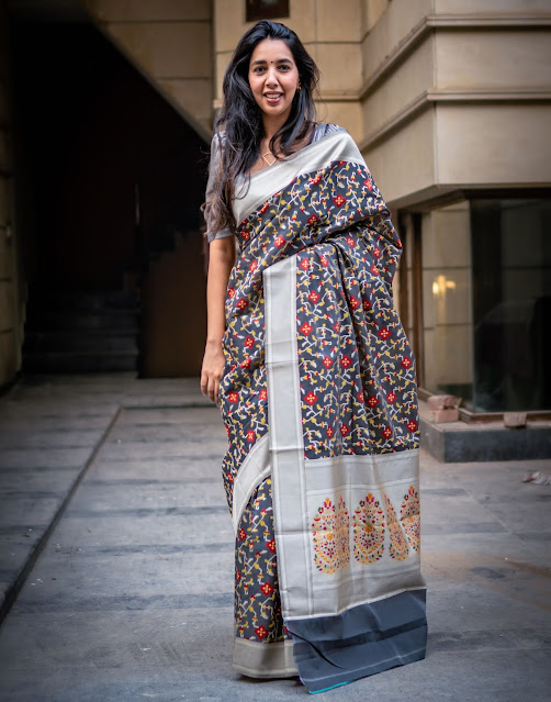 Banarasi silk saree with patola design body and paithani style pallu in cement grey.