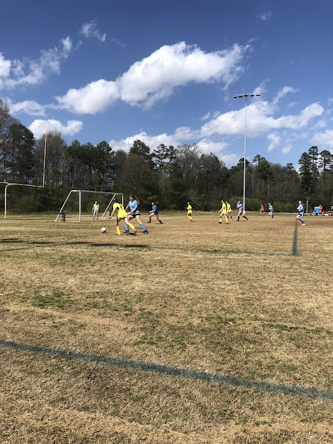 Elizabeth challenging the ball over by her own goal.