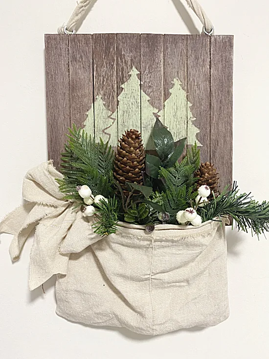 pallet with trees and muslin pouch with greens