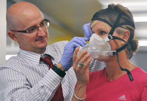 Iñigo San Millán, Ph.D putting a face mask on a test subject.