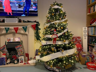 Christmas tree with Elf on the Shelf and toilet paper