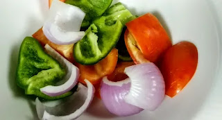 Cube size vegetables like capsicum bell peppers onions and tomatoes for malai paneer tikka