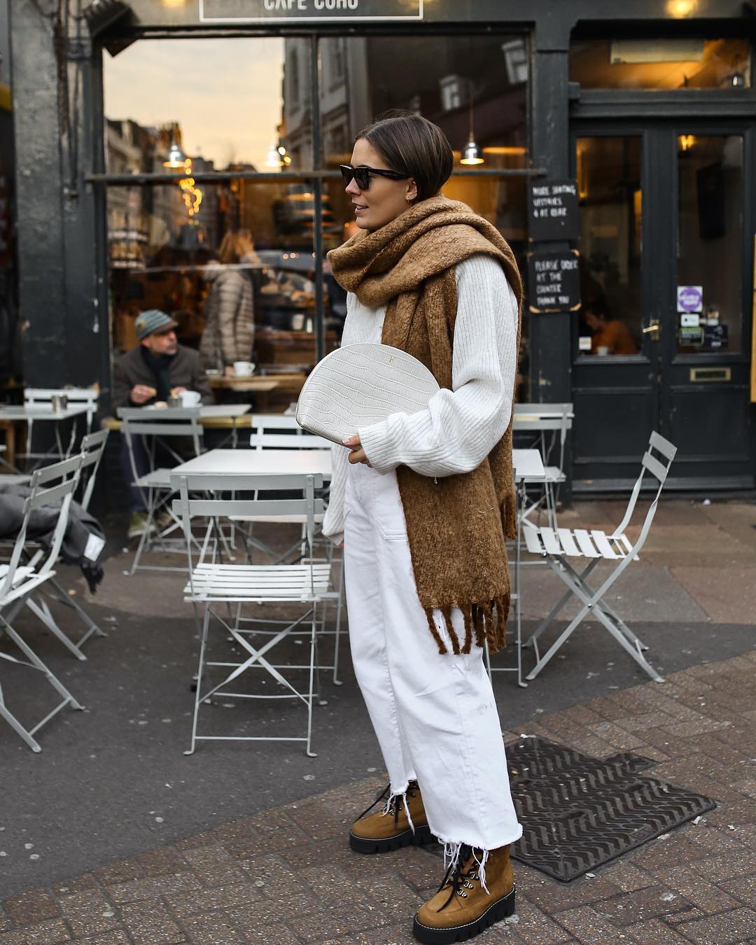 23 Oversized Scarves For Winter Outfit — Hannah Crosskey Instagram Style In a Camel Tan Blanket Scarf, White Sweater, White Denim and Lace Up Boots