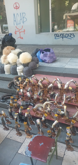 Handicrafts and hats being sold on Rustaveli pavement.