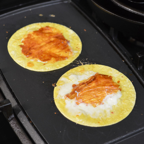 The taco shells are unique, having a cheese crust griddled onto them.