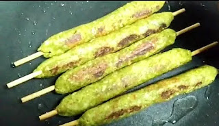 Cooking or roasting veg seekh kabab sticks on a tawa or pan