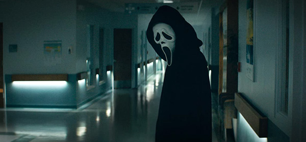 Ghostface prepares to wreak havoc inside the hospital corridor in SCREAM.