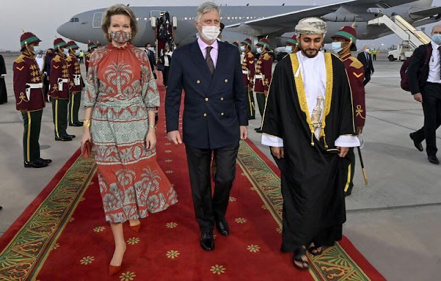 Queen Mathilde wore a new multi ataraxia ruched crepe dress from Johanna Ortiz. The Sultanate of Oman and the United Arab Emirates