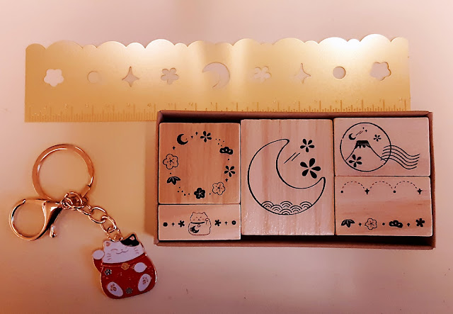 Elegant golden ruler with Tsuki stencils, a beautiful Japanese themed stamp set and a maneki-neko keychain