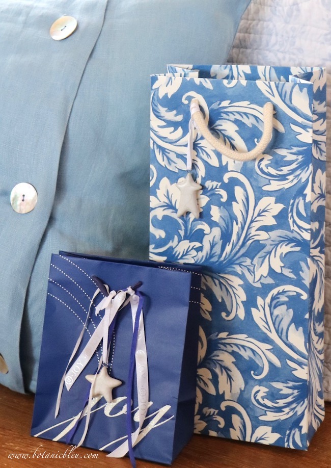 White ceramic stars dress up a blue and white French scroll bottle bag.