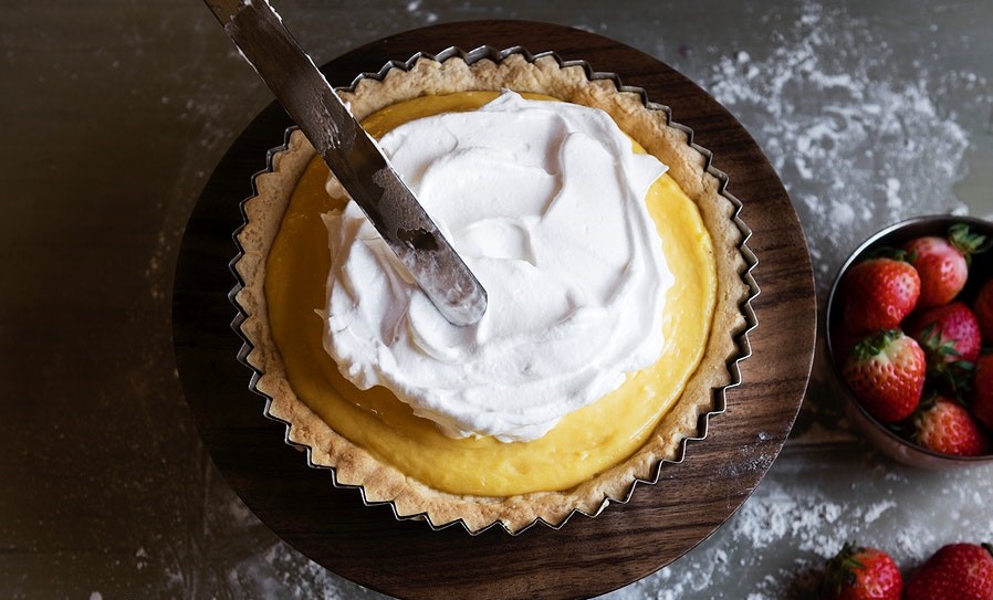 spreading meringue over pie