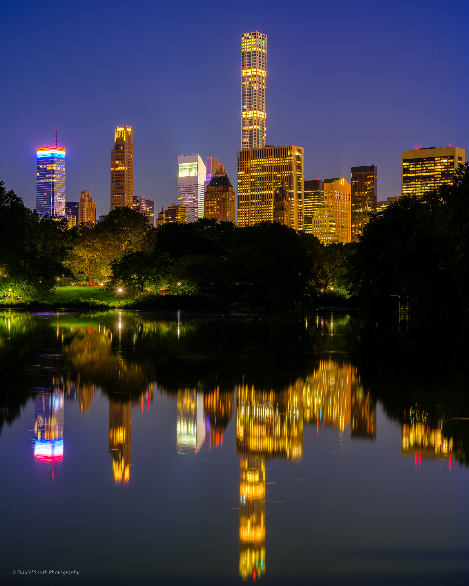 a photo of the new york skyline from central park at night