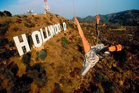 actress Michelle Yeoh suspended from a helicopter over the famous Hollywood sign, California, 1998