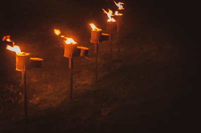 A row of flames burning against a dark background