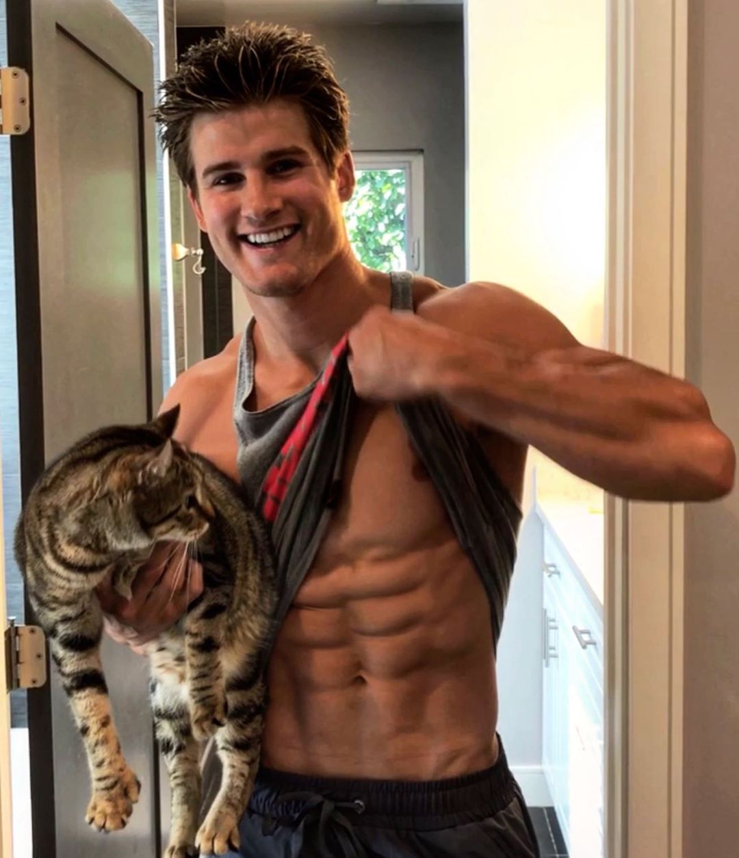 hot-fit-guy-abs-smile-petting-cat