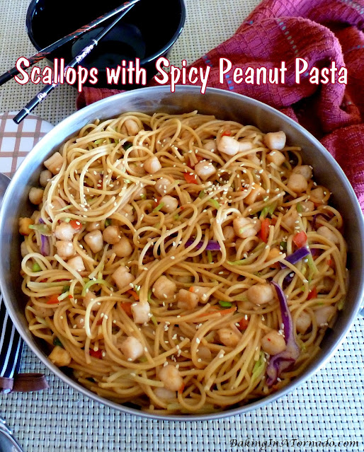 Scallops with Spicy Peanut Sauce, bay scallops are tossed with vegetables and pasta in a spicy peanut sauce. | recipe developed by www.BakingInATornado.com | #recipe #dinner