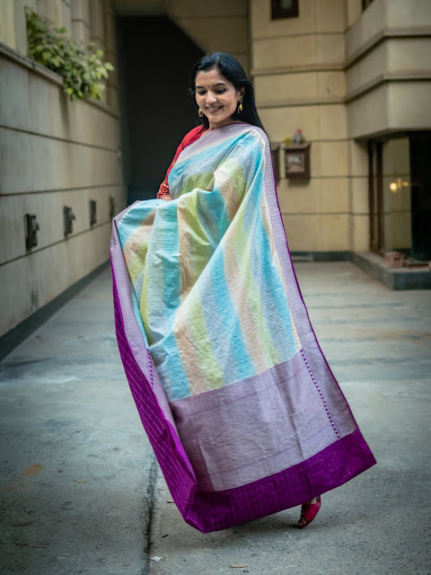 Banarasi silk saree with patola design body and paithani style pallu in cement grey.