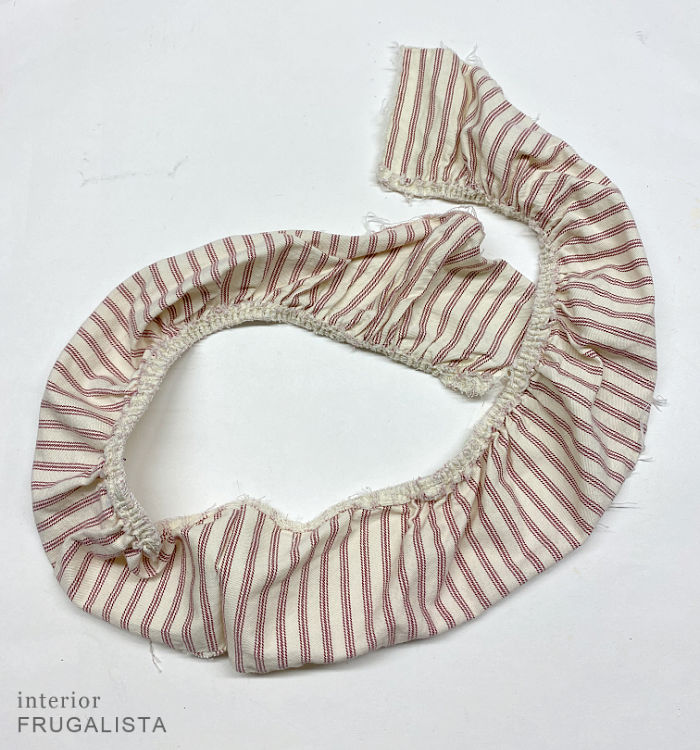 A red ticking stripe chair slipcover ruffle remnant to embellish a DIY heart wreath.