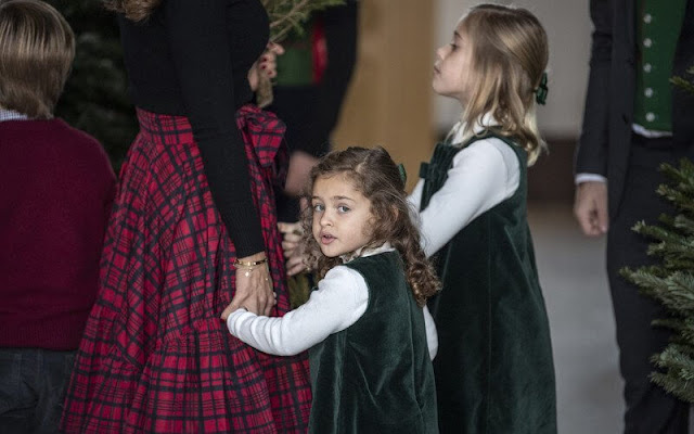 Princess Leonore and Princess Adrienne wore an emerald velvet pinafore dress by Trotters Kids. Chris O'Neill and Prince Nicolas