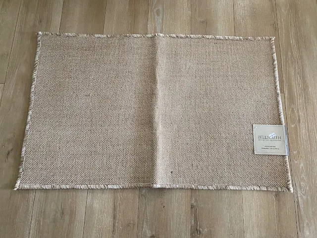 Photo of a plain small woven jute area rug.