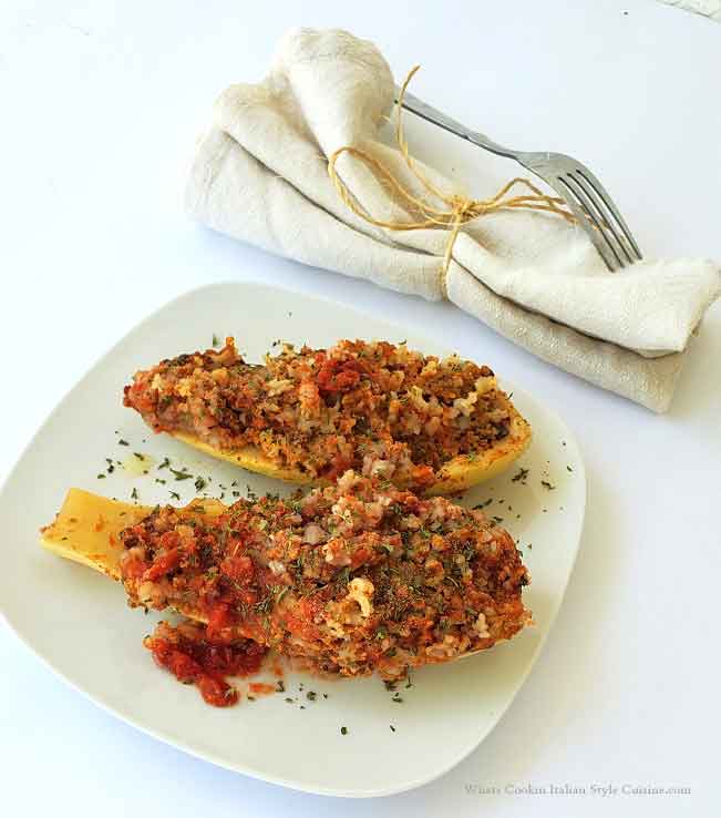 slow cooker stuffed squash on the white plate with a fork and  cloth tied napkin